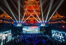 Chinese and foreign media delegates attend a illuminated cultural and smart manufacturing light show in front of a illuminated traditional pagoda stage in Wuhan, China.