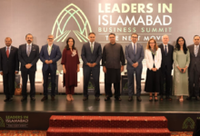 LIIBS 2026, group photograph of business leaders and speakers standing on stage at the Leaders in Islamabad Business Summit 2026, with the event backdrop displaying the theme “The Next Move.